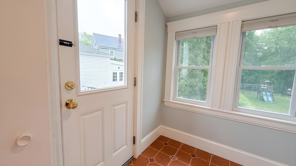 114 Curve Street Dedham, MA 02026 - Photo 14 of 27 a view of an entryway with wooden floor and windows