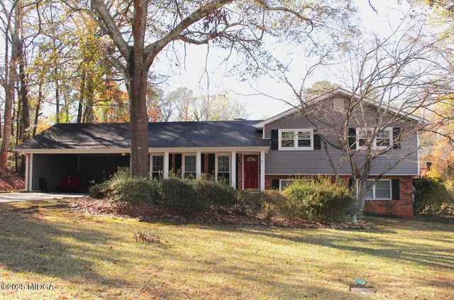a view of a house with snow on a tree