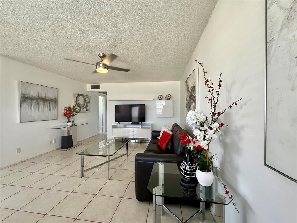 144 Farnham F Deerfield Beach, FL 33442 - Photo 1 of 36 a living room with furniture and a flat screen tv