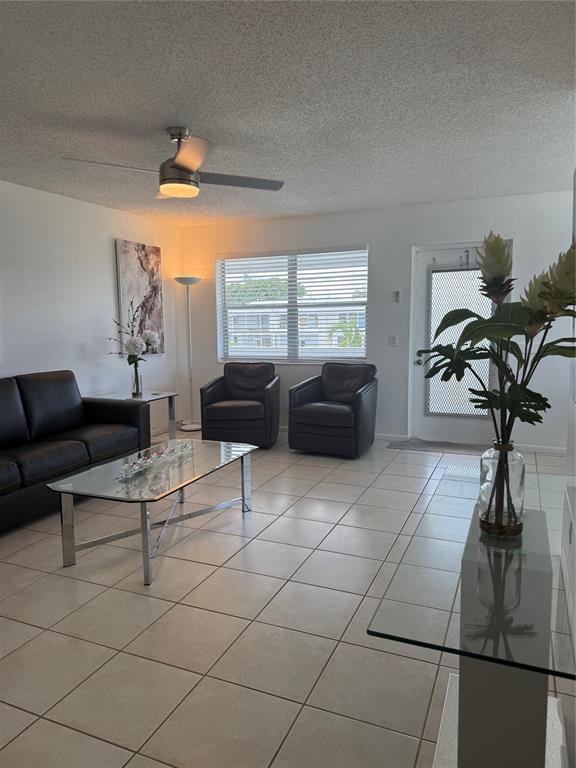 144 Farnham F Deerfield Beach, FL 33442 - Photo 11 of 36 a living room with furniture and a potted plant