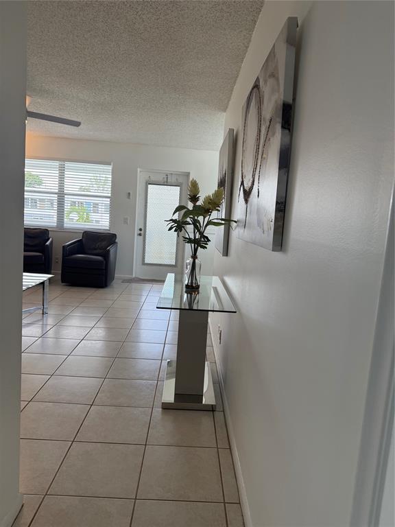 144 Farnham F Deerfield Beach, FL 33442 - Photo 12 of 36 a living room with furniture and a chandelier