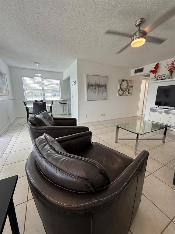 144 Farnham F Deerfield Beach, FL 33442 - Photo 13 of 36 a living room with furniture and a flat screen tv