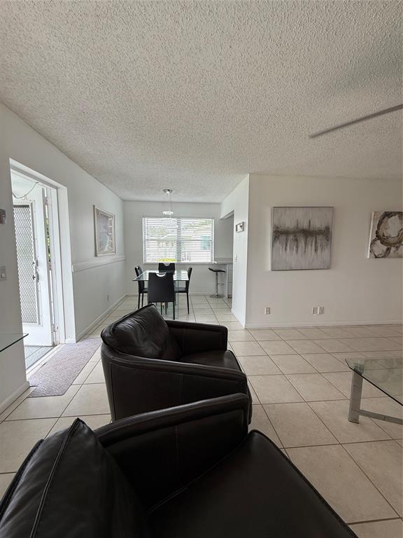 144 Farnham F Deerfield Beach, FL 33442 - Photo 14 of 36 a living room with furniture and a flat screen tv