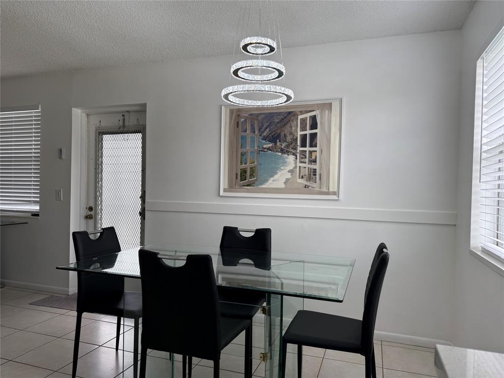 144 Farnham F Deerfield Beach, FL 33442 - Photo 15 of 36 a dining room with furniture and window