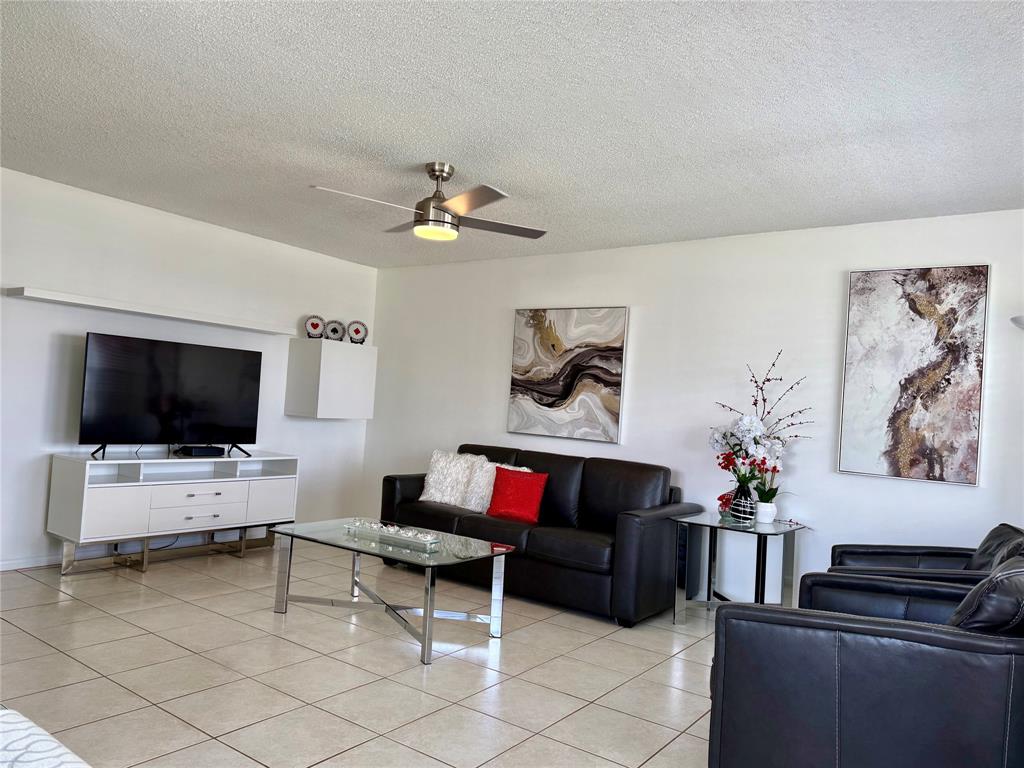 144 Farnham F Deerfield Beach, FL 33442 - Photo 2 of 36 a living room with furniture and a flat screen tv