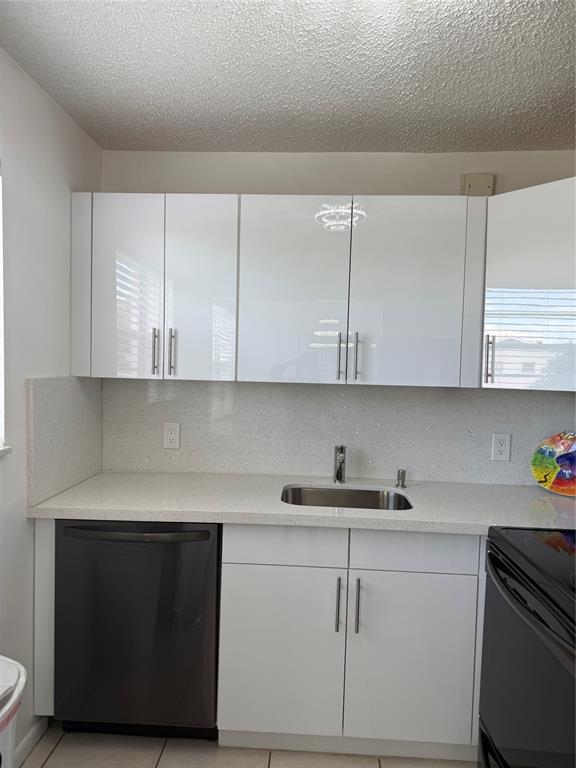144 Farnham F Deerfield Beach, FL 33442 - Photo 23 of 36 a kitchen with cabinets appliances and a sink