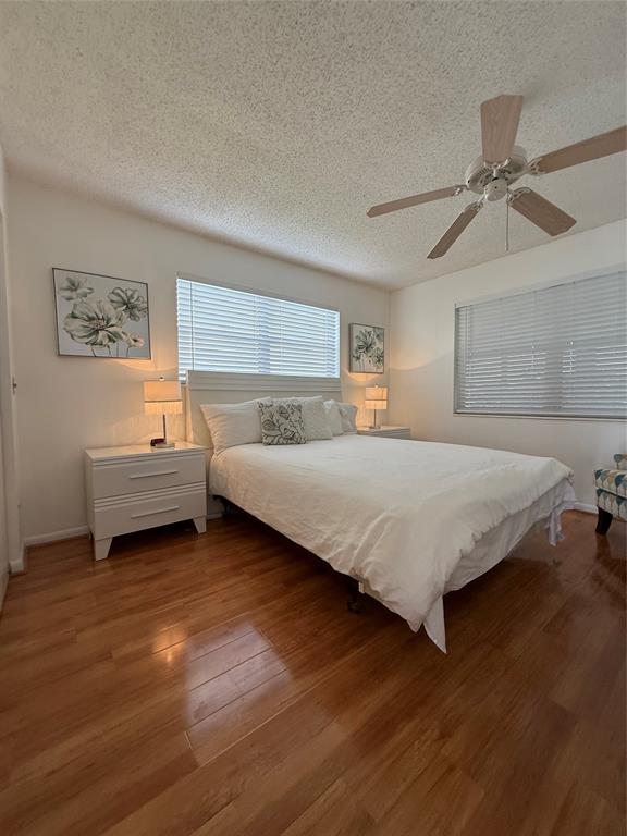 144 Farnham F Deerfield Beach, FL 33442 - Photo 27 of 36 a bedroom with a bed and a chandelier