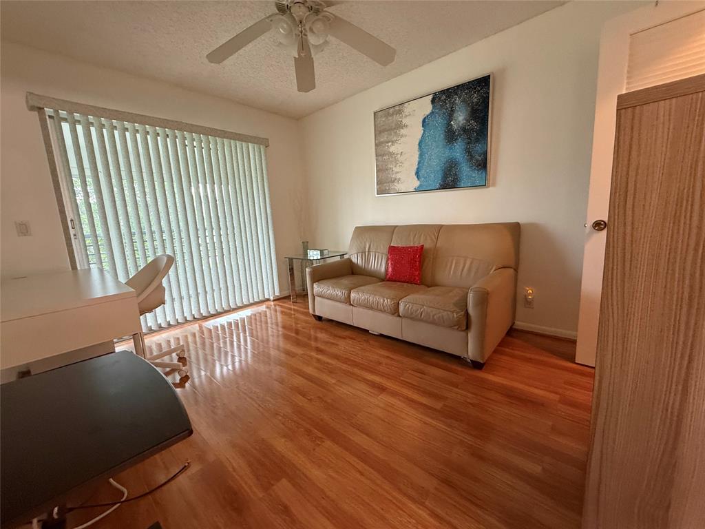 144 Farnham F Deerfield Beach, FL 33442 - Photo 28 of 36 a living room with furniture and a wooden floor