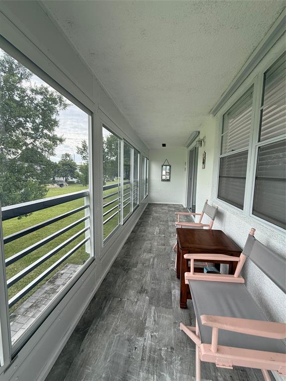 144 Farnham F Deerfield Beach, FL 33442 - Photo 29 of 36 a room with furniture and large windows