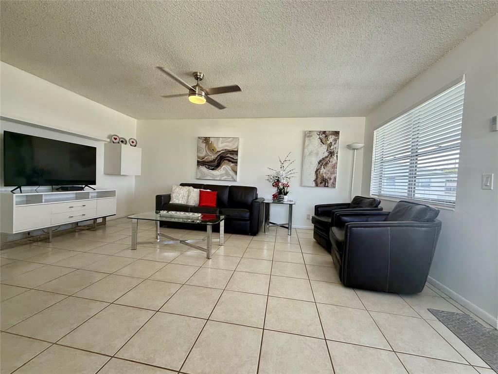 144 Farnham F Deerfield Beach, FL 33442 - Photo 3 of 36 a living room with furniture and a flat screen tv