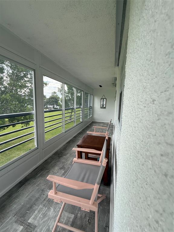 144 Farnham F Deerfield Beach, FL 33442 - Photo 32 of 36 a living room with a bed