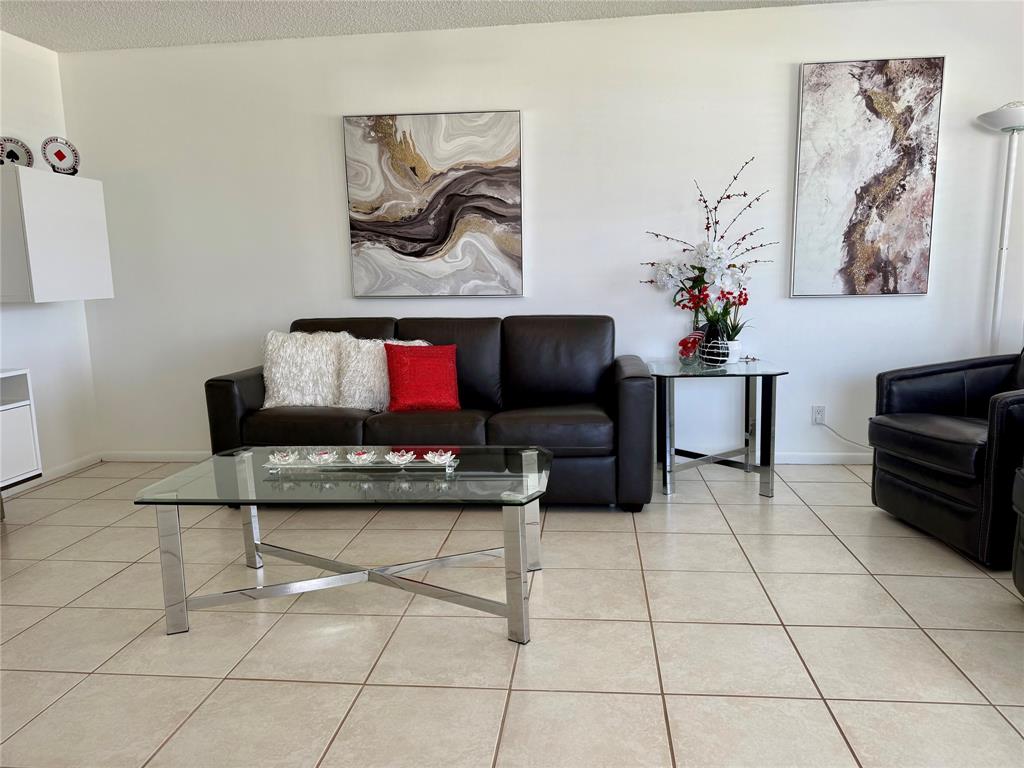 144 Farnham F Deerfield Beach, FL 33442 - Photo 4 of 36 a living room with furniture and a flat screen tv