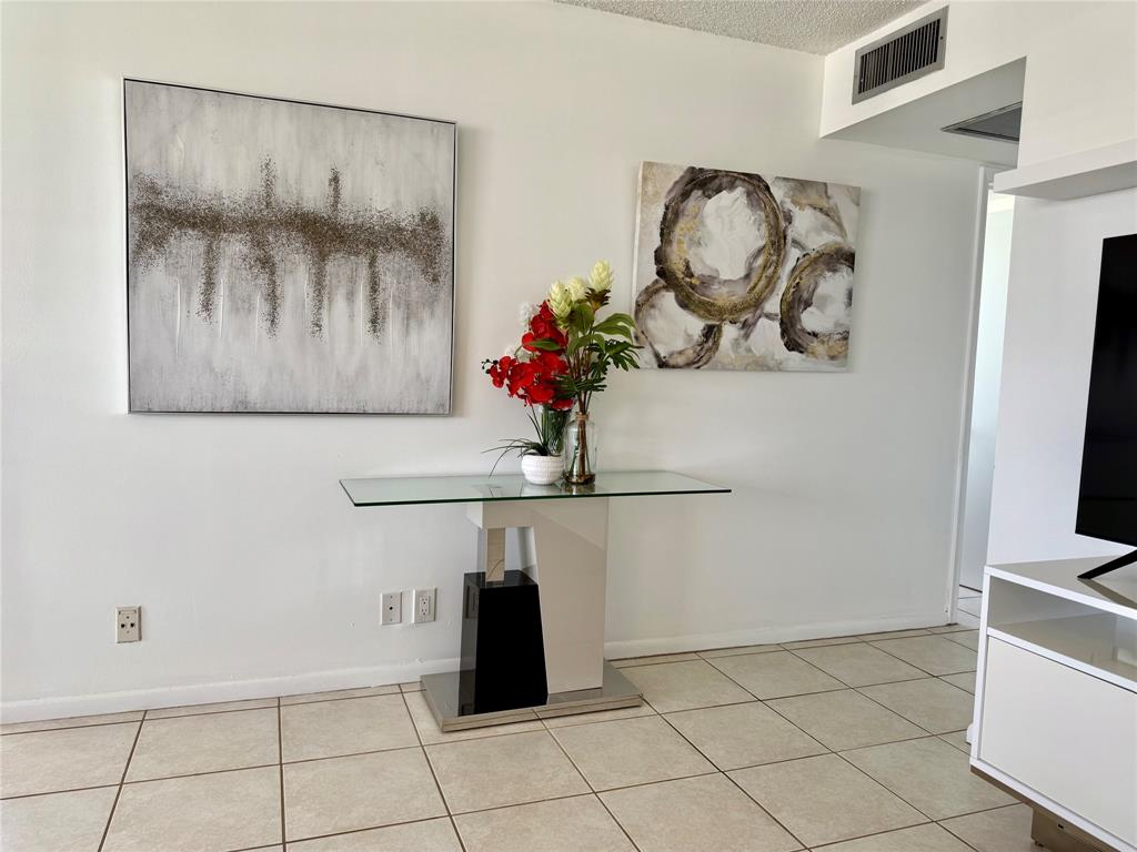 144 Farnham F Deerfield Beach, FL 33442 - Photo 7 of 36 a bathroom with a sink and a mirror