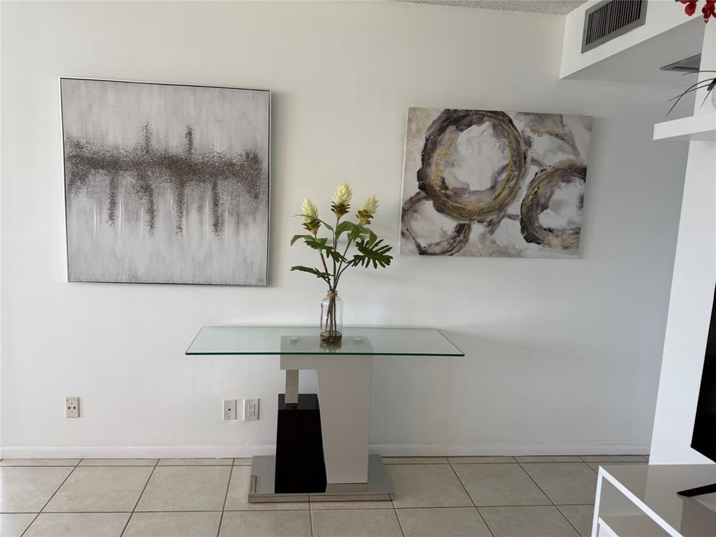 144 Farnham F Deerfield Beach, FL 33442 - Photo 8 of 36 a vase of flowers sitting on a table