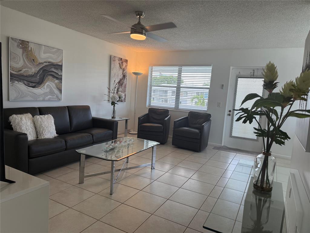 144 Farnham F Deerfield Beach, FL 33442 - Photo 9 of 36 a living room with furniture a window and a potted plant