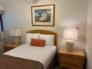 3411 Wilcox Road, Unit IIII109 Lihue, HI 96766 - Photo 5 of 12 a bedroom with a bed and a painting on the wall