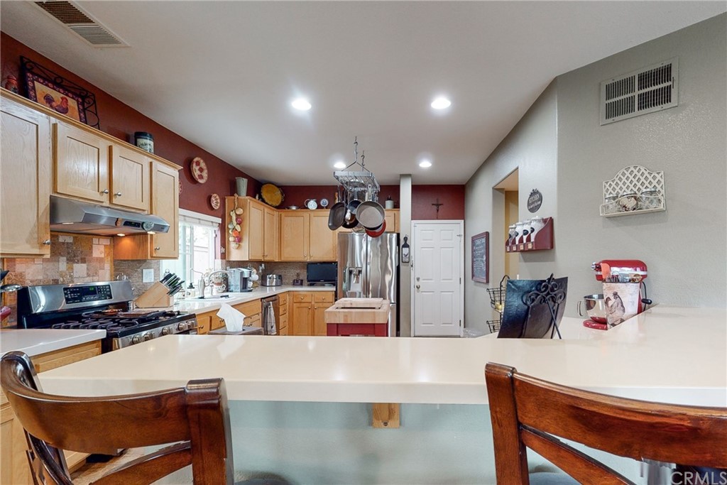 3199 Toopal Drive Oceanside, CA 92058 - Photo 18 of 47 a large kitchen with a table and chairs