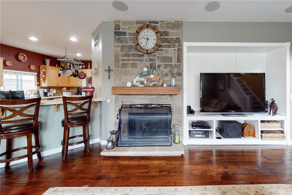 3199 Toopal Drive Oceanside, CA 92058 - Photo 21 of 47 a living room with furniture a flat screen tv and a fireplace