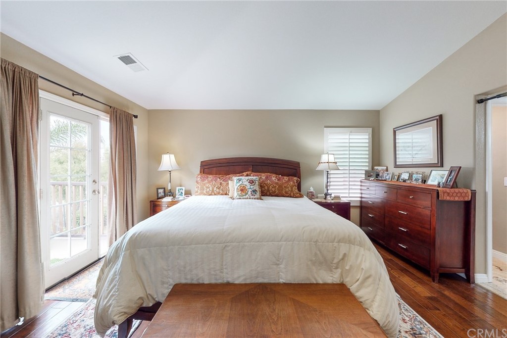 3199 Toopal Drive Oceanside, CA 92058 - Photo 28 of 47 a bedroom with a bed and wooden floor