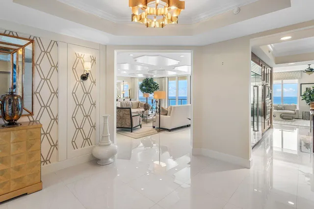 a view of a dining room with furniture and chandelier