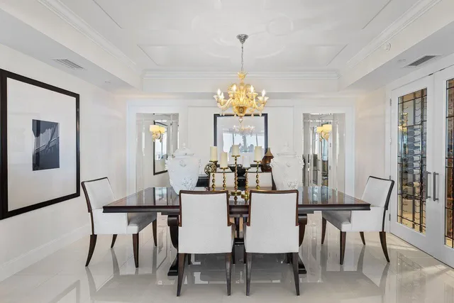 a spacious bedroom with a bed and a chandelier