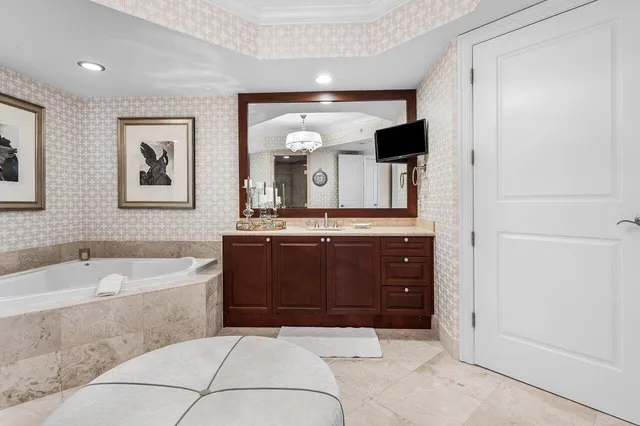 a living room with fireplace furniture and a large window