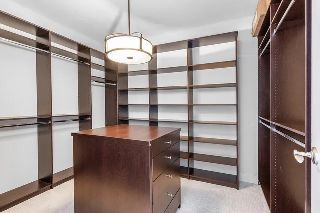a living room with furniture and floor to ceiling windows