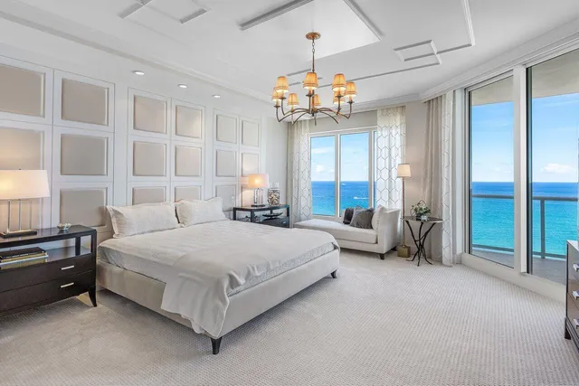 a living room with fireplace furniture and a potted plant