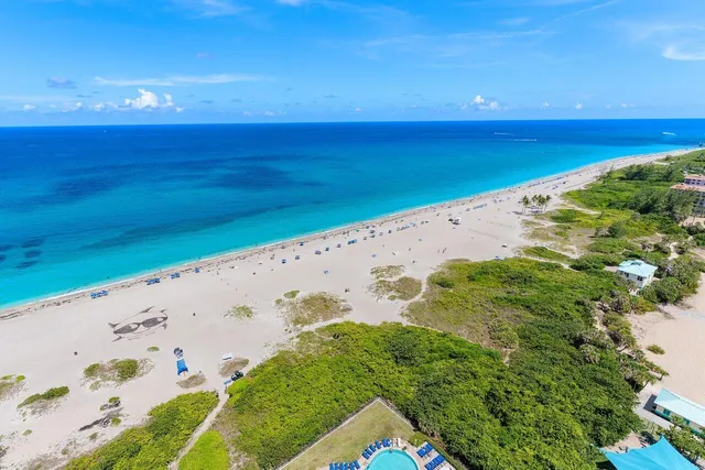 a living room with lots of furniture and kitchen view