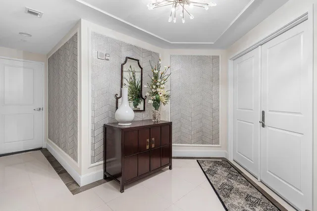 a view of a dining room with furniture and chandelier