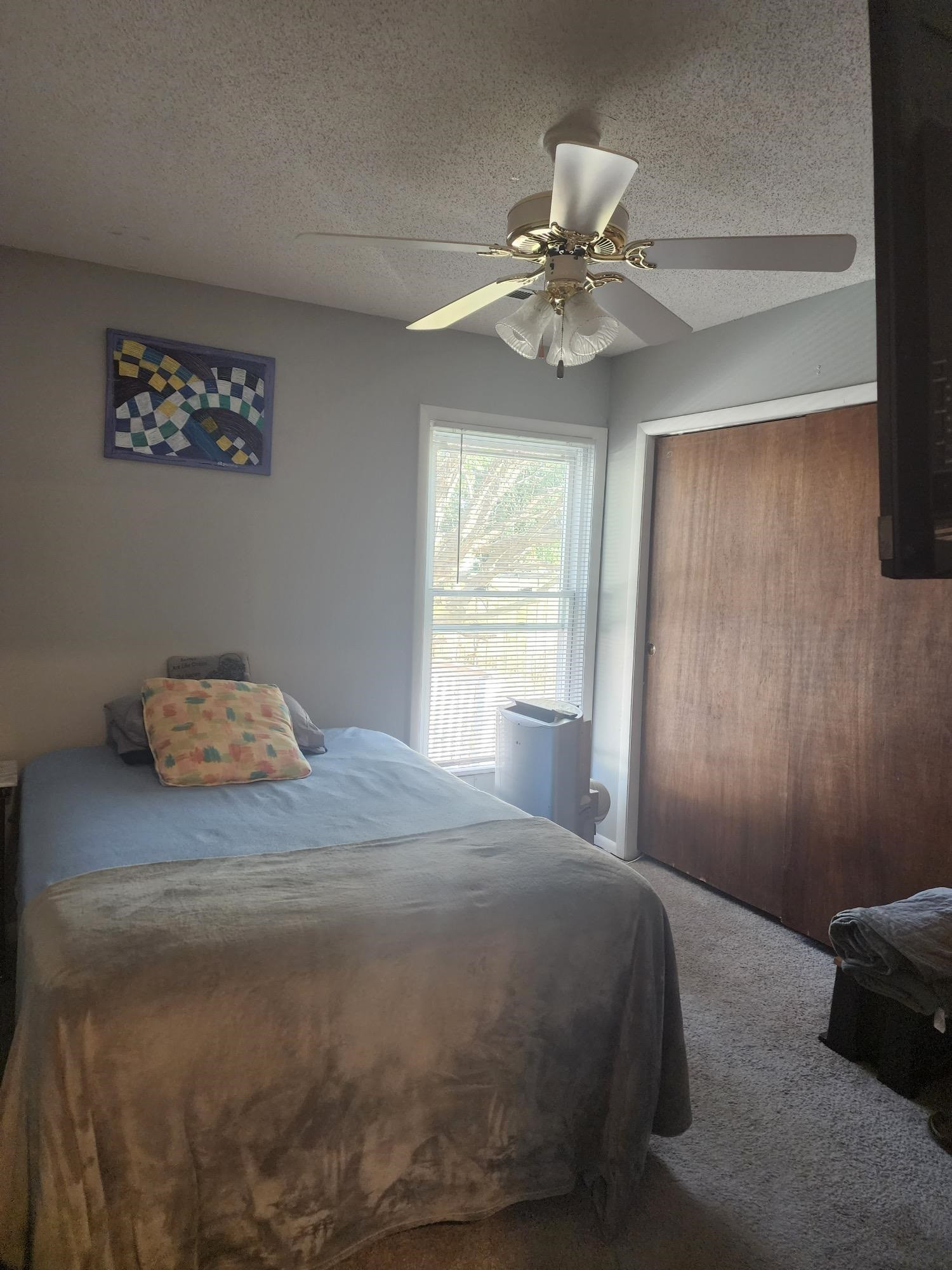 109 Marvin Drive Spring Lake, NC 28390 - Photo 12 of 13 a bedroom with a bed and a chandelier