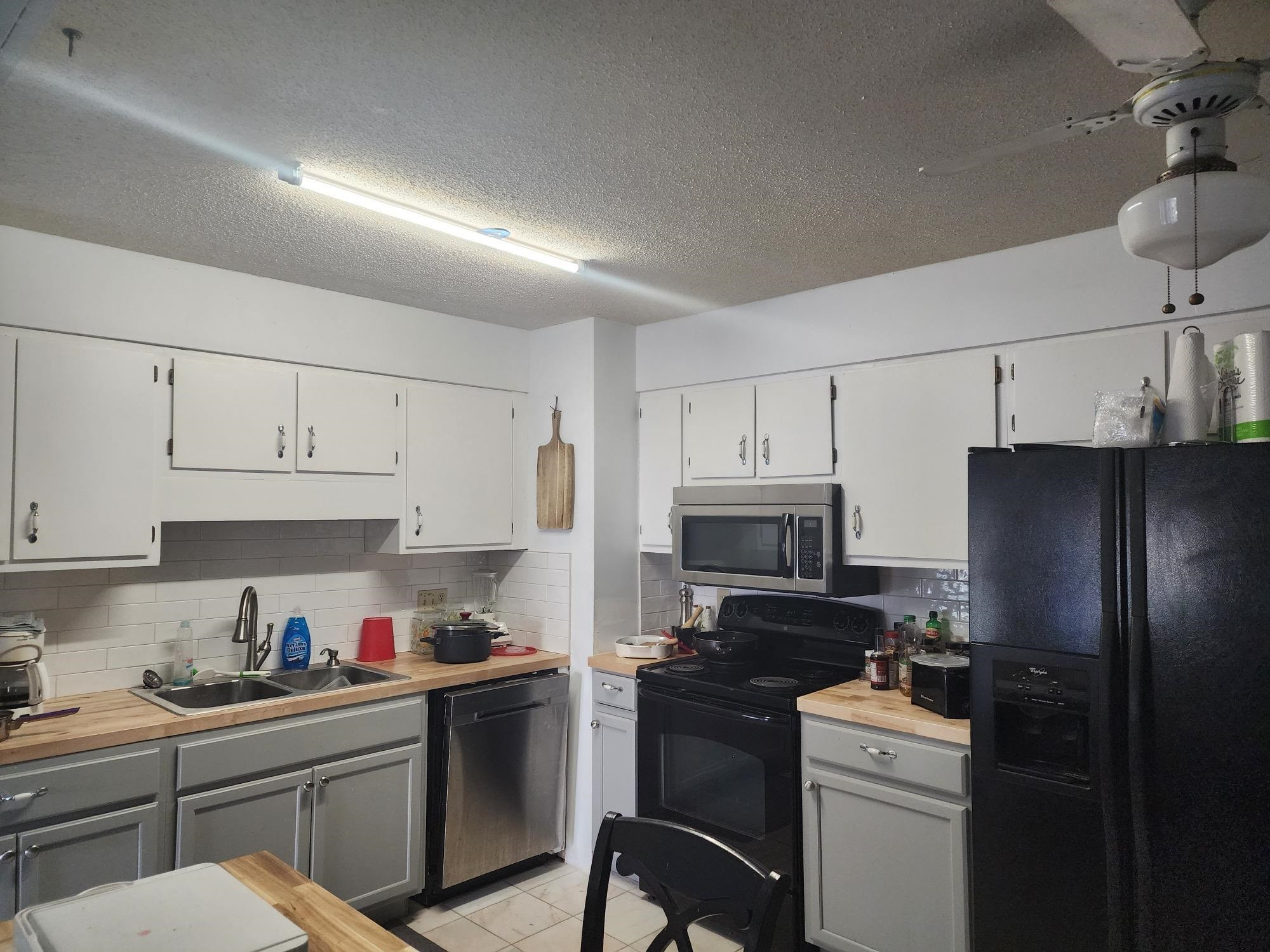 109 Marvin Drive Spring Lake, NC 28390 - Photo 5 of 13 a kitchen with stainless steel appliances a stove refrigerator sink and cabinets