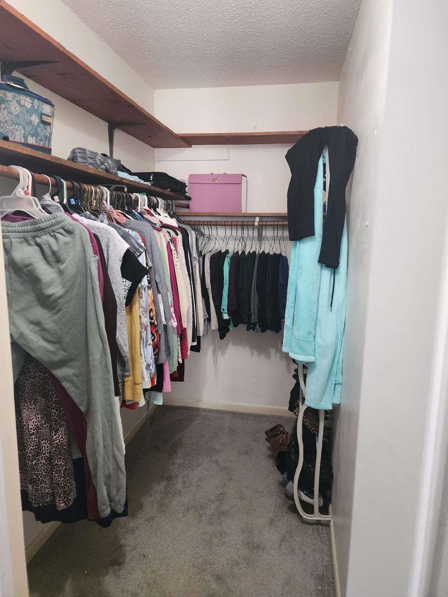 109 Marvin Drive Spring Lake, NC 28390 - Photo 9 of 13 a view of walk in closet with clothes and shoes