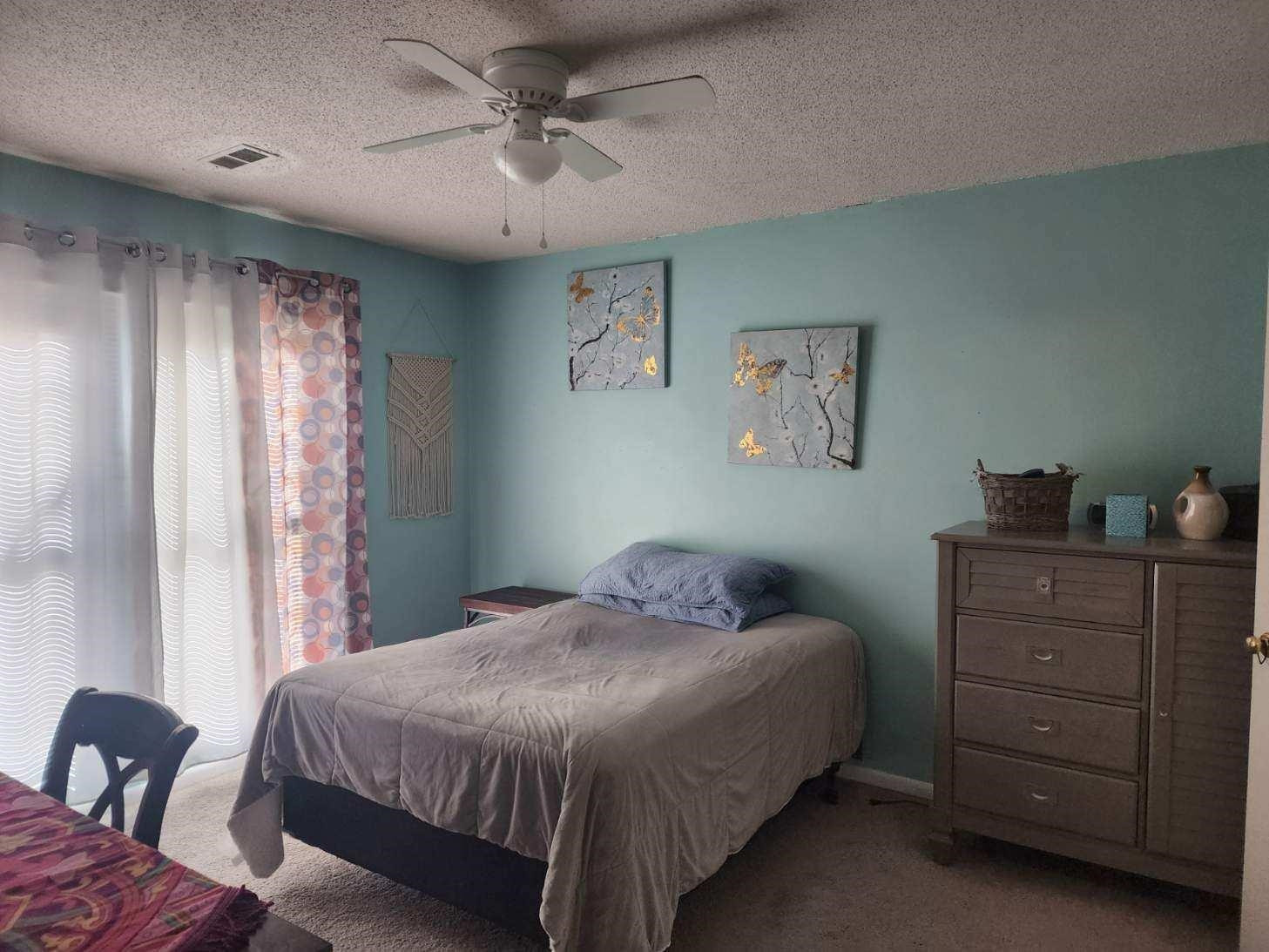 109 Marvin Drive Spring Lake, NC 28390 - Photo 10 of 13 a bedroom with a bed and a chandelier