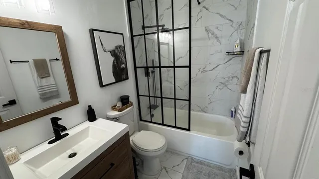 a bathroom with a sink toilet and shower