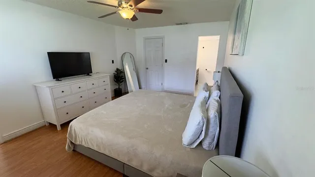 a bedroom with a bed and a television