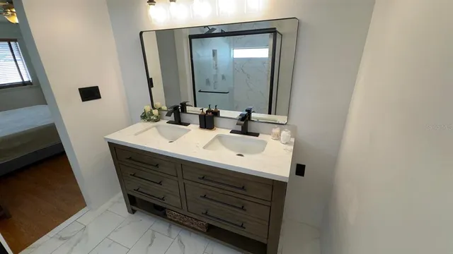 a bathroom with a sink vanity and mirror