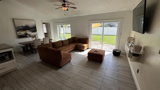 a living room with furniture fireplace and flat screen tv