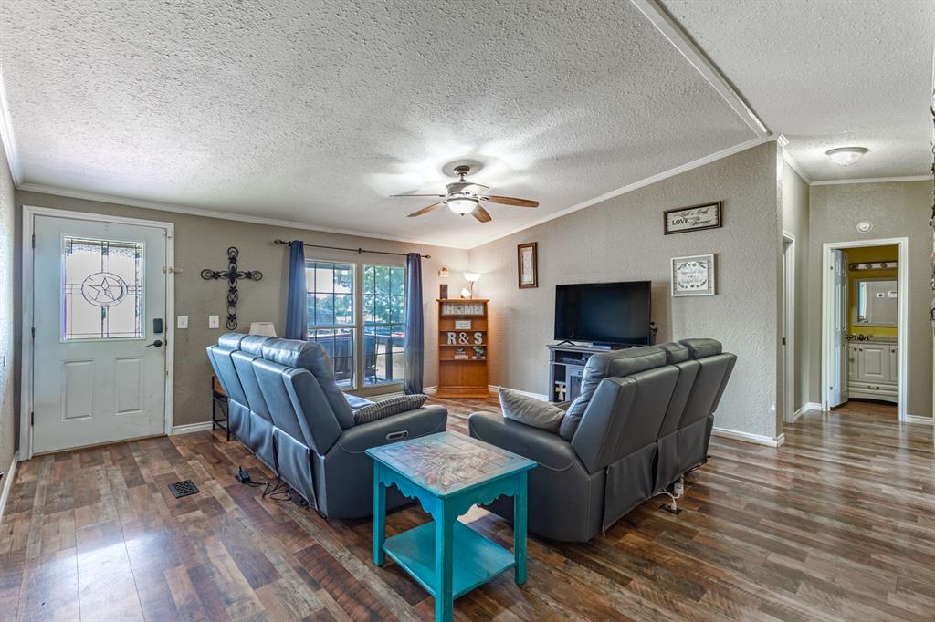 75 Southern Road Mineral Wells, TX 76067 - Photo 10 of 31 a living room with furniture and a flat screen tv