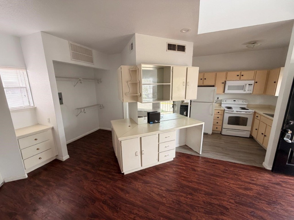 7901 Cambridge Street, Unit 133 Houston, TX 77054 - Photo 2 of 14 a kitchen with white cabinets and white appliances