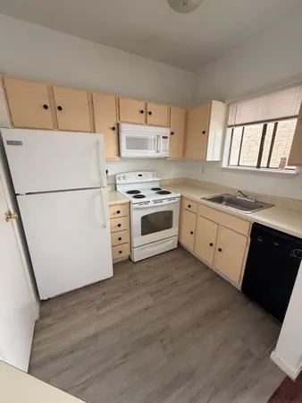 a kitchen with a white cabinets and white appliances