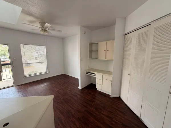 a kitchen with a refrigerator and a stove top oven