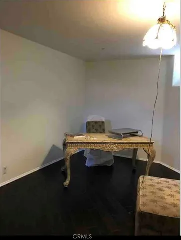 a living room with a wooden floor and furniture