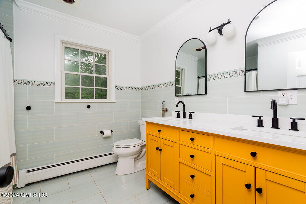 25 Griffith Road Riverside, CT 06878 - Photo 18 of 27 a bathroom with a double vanity sink a toilet and a mirror