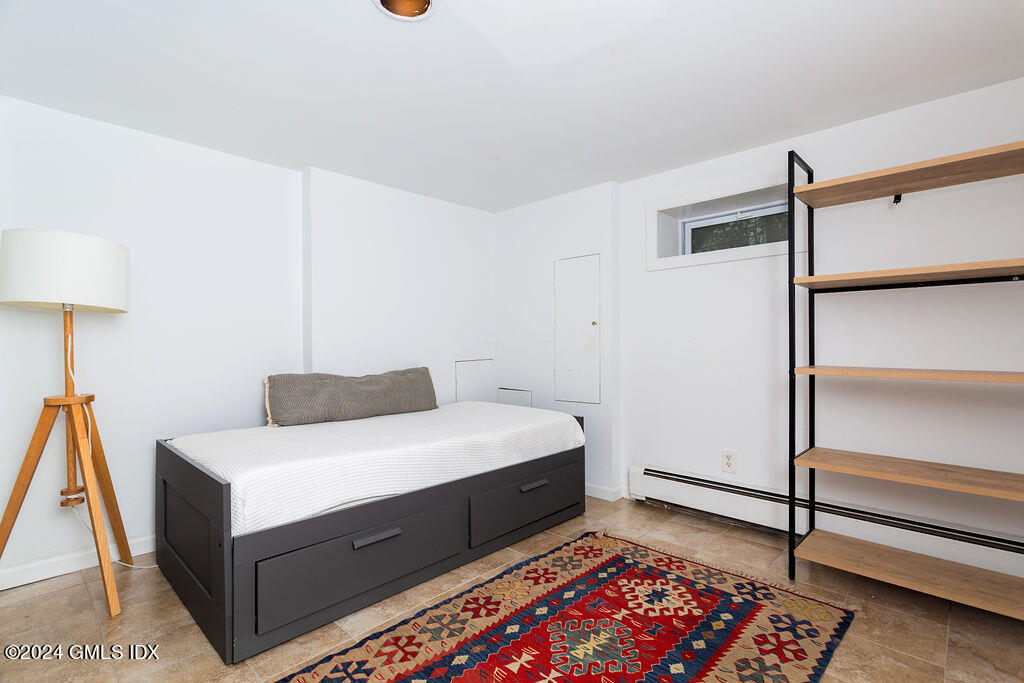 25 Griffith Road Riverside, CT 06878 - Photo 21 of 27 a room with a bed and a lamp on the dresser