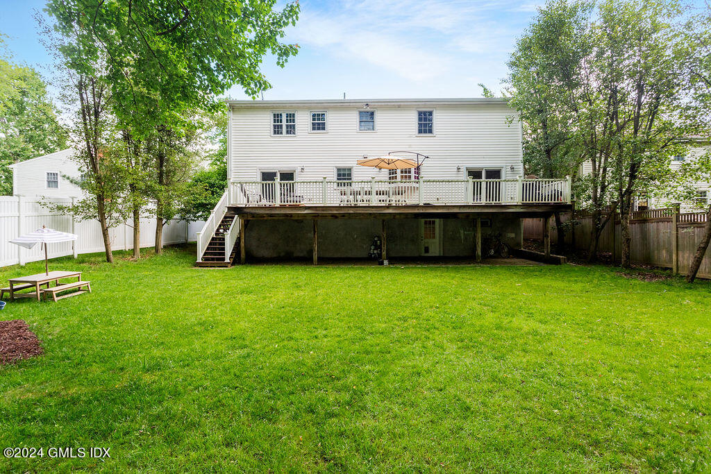 25 Griffith Road Riverside, CT 06878 - Photo 22 of 27 a front view of a house with a garden and deck