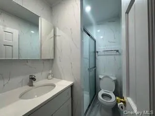 a bathroom with a sink toilet and shower