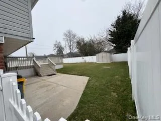 a view of a backyard with sitting area