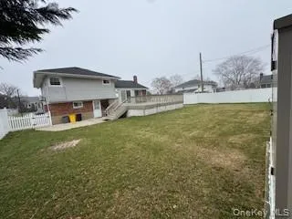 a view of a house with a yard and sitting area