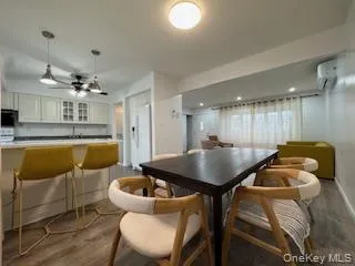 a kitchen with a table chairs sink and cabinets